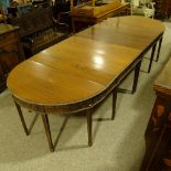 A large 19th century Anglo-Indian padouk wood 4-section D-end dining table, with leaf carved edge