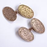 A pair of early 20th century 9ct rose gold oval panel cufflinks, floral engraved decoration,