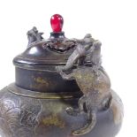 A Chinese patinated bronze incense burner, with dragon cast handles and relief moulded side