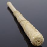 A 19th century relief carved bone parasol handle, with tassel and rope decoration, length 24cm