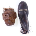 A Dan Tribal stained wood bird mask, height 40cm, and a Native American carved wood mask (2)