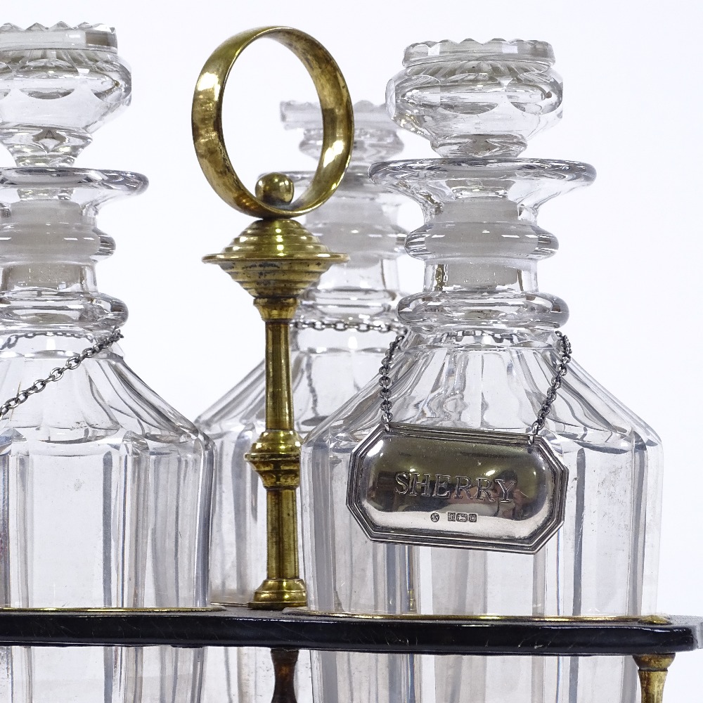 A 19th century brass-mounted ebonised wood 3 bottle decanter stand with brass carrying handle,