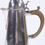 A George V silver lighthouse design hot water jug, tapered cylindrical form with turned wood