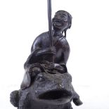 A Chinese patinated bronze sculpture of a man riding a toad, height to man's head 16cm Probably