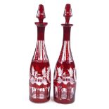 A pair of 19th century Bohemian ruby overlay glass decanters, with wheel-cut panel decoration,