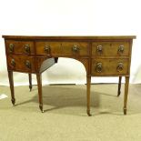 George III mahogany bow-front knee-hole sideboard, with brass lion ring handles and tapered legs,
