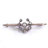 An early 20th century 9ct rose gold pearl and diamond horseshoe bar brooch, total diamond content