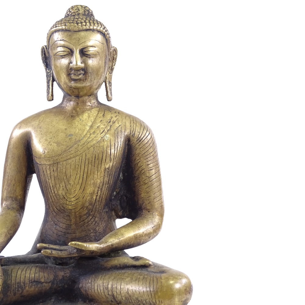 An Oriental polished bronze seated Buddha, height 37cm