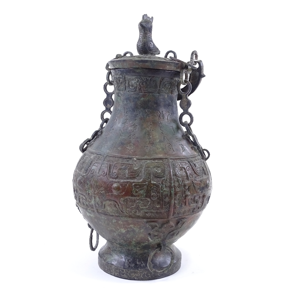 A large Chinese verdigris bronze flagon and cover, with relief moulded decoration and text, bird - Image 2 of 6