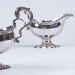 A pair of George III silver pedestal sauce boats, gadrooned rim and foot with scrolled acanthus leaf