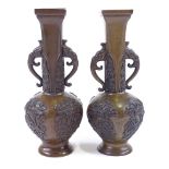 A pair of Japanese patinated bronze 2-handled vases, relief moulded decoration, seal marks under,