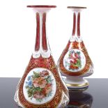 A pair of Bohemian ruby and milk overlay glass narrow-necked vases, with hand painted floral