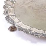 A George II circular silver salver, cast relief floral border with bright-cut engraved decoration,