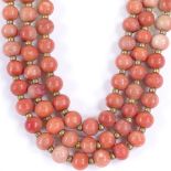 A Victorian triple-strand coral/stained ivory necklace, gilt-metal floral clasp, necklace length