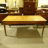 A 19th century French fruitwood farmhouse dining table with plank top, single side frieze drawer and