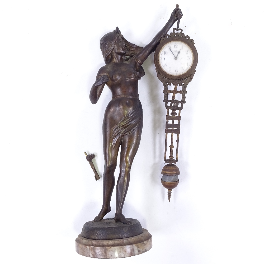 A 19th century French patinated spelter Mystery clock, supported by a Classical figure - Image 2 of 4