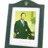 A signed photograph of Prince Charles, in original leather frame with Prince of Wales gilded emblem,