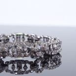 An Art Deco unmarked white metal diamond panel bracelet, calculated total diamond content approx