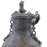 A large Chinese verdigris bronze flagon and cover, with relief moulded decoration and text, bird