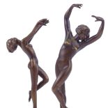 A pair of Art Deco style patinated bronze naked dancing girls, on coloured marble plinth bases,