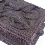 An African or Asian carved wood box with relief carved cobra and crocodile decorated lid, length