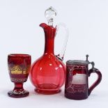 A Victorian ruby glass Claret jug, a Bohemian ruby overlay glass tankard, and a Bohemian ruby