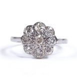 An unmarked white gold diamond cluster flowerhead dress ring, calculated total diamond content