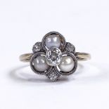 An early 20th century unmarked gold pearl and diamond trefoil dress ring, central diamond approx 0.