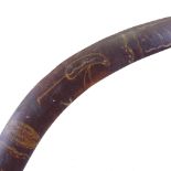 An Australian Aboriginal stained wood boomerang, with painted Tribal designs and emu, late 19th or