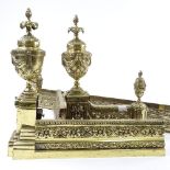An ornate Victorian cast-brass fire fender, with urn mounts