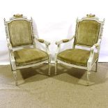 A pair of French carved painted and gilded wood-framed open arm salon chairs