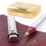 A Cartier plated rollerball pen in original leather wallet, and a Dupont gold plated pocket