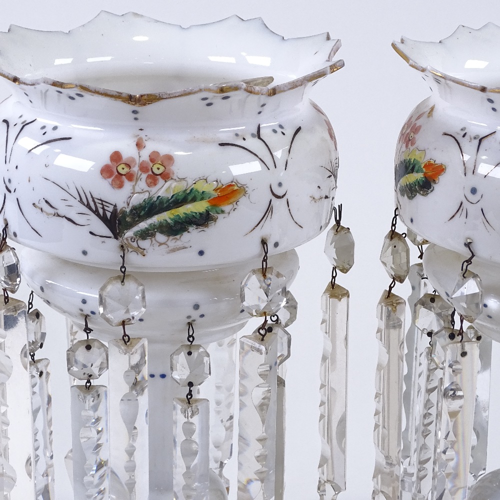 A pair of Victorian milk glass table lustres, with clear glass arrowhead drops and painted