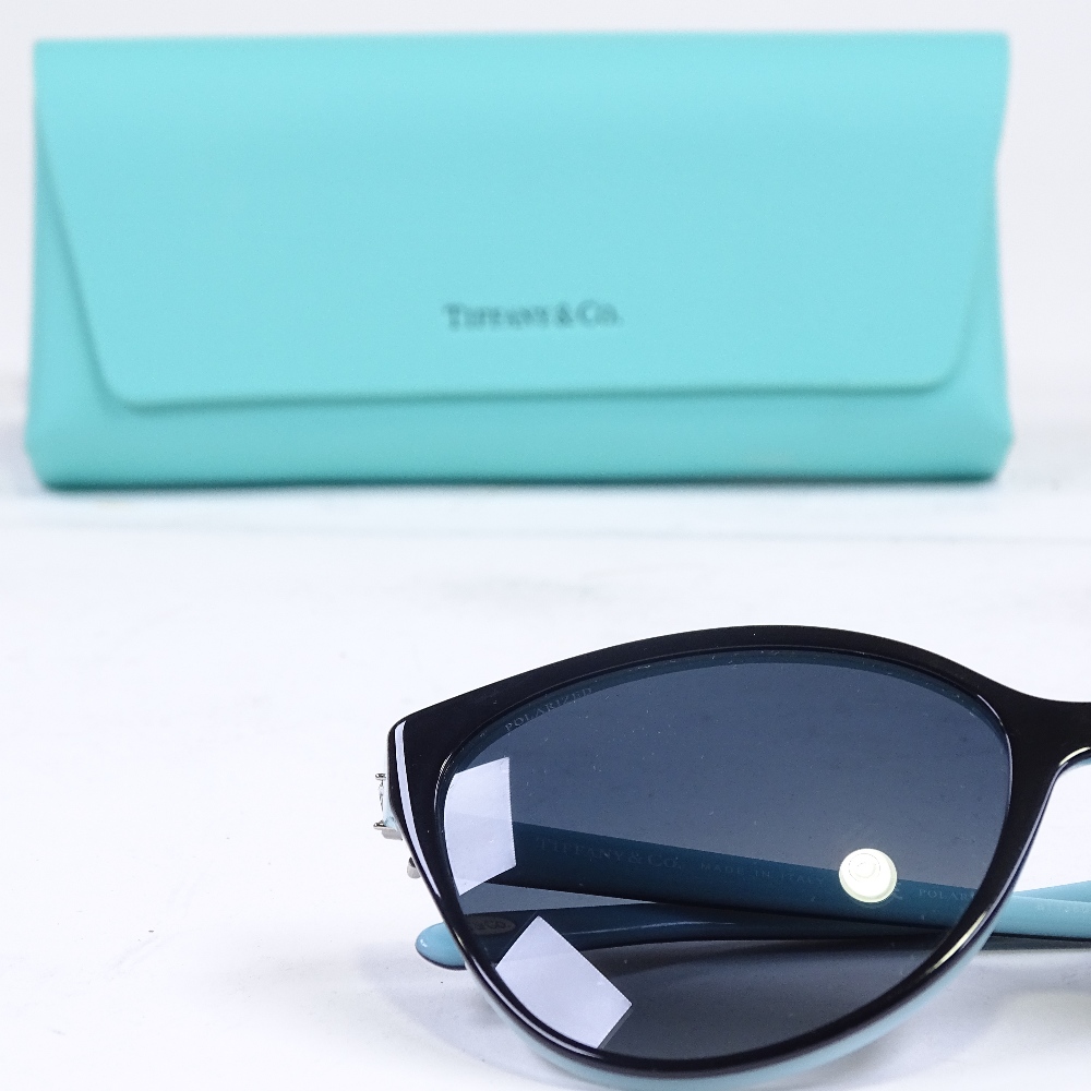A pair of new Tiffany & Co black and blue framed sunglasses, leather-cased, RRP £335