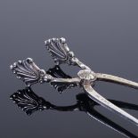 GEORG JENSEN - a pair of Danish sterling silver Dronning pattern sugar tongs, acanthus decoration