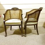 A pair of early 20th century mahogany-framed bergere tub chairs, with cane-panelled backs and carved