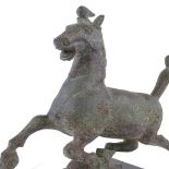 A Chinese verdigris bronze galloping horse, after the Antique, on wooden stand, height 30cm,
