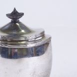 A George V silver boat-shaped tea caddy, bulbous form with reeded edge and turned wood knop, by