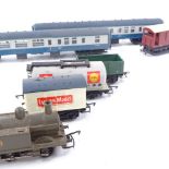 An OO gauge model railway locomotive, passenger carriages and tenders