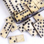 A set of bone and ebony dominos in Coronation box