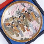 A Japanese Satsuma plate, gathering maidens, signed, diameter 13cm, boxed