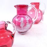 3 cranberry glass jugs, including example with hand painted decoration, largest height 15cm (3)