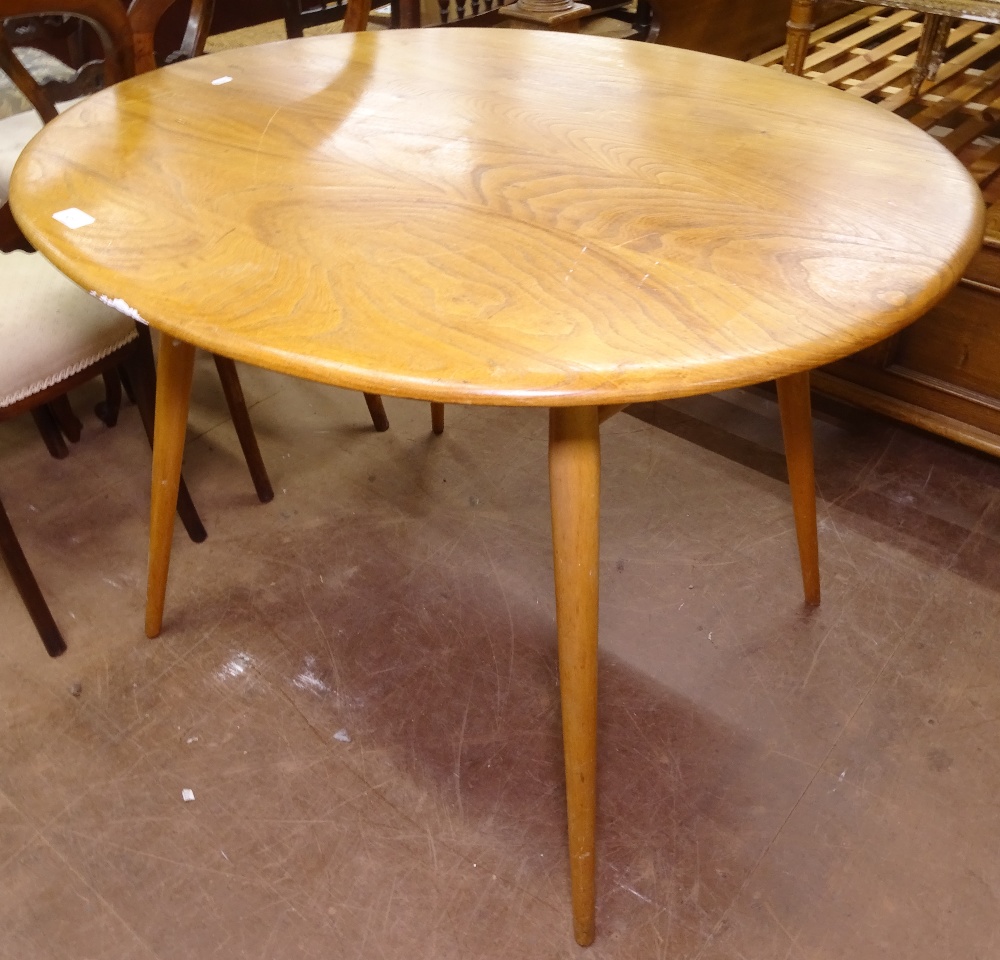 An Ercol elm and beech oval kitchen table on turned legs, W100cm, H73cm