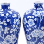 A pair of Chinese porcelain blue and white Prunus pattern Meiping vases, 6 character mark on base,