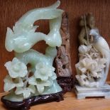 A collection of various Oriental soapstone and jadeite carvings, including water buffalo and birds-