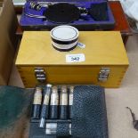 Boxed brass Avery weights, a wallet with glass medicine tubes, a mahogany scale and weights, and a