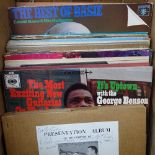 A box of LP records, including George Benson, June Christy, and Tony Bennett