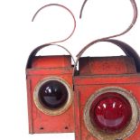 A pair of Chalwyn painted metal railway lanterns, with coloured glass bullseye lenses