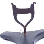 A 19th century cast-iron boot scraper, on large later black marble tri-form base, overall height