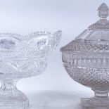 A large moulded glass table centre pedestal jar and cover, and a similar pedestal bowl, largest